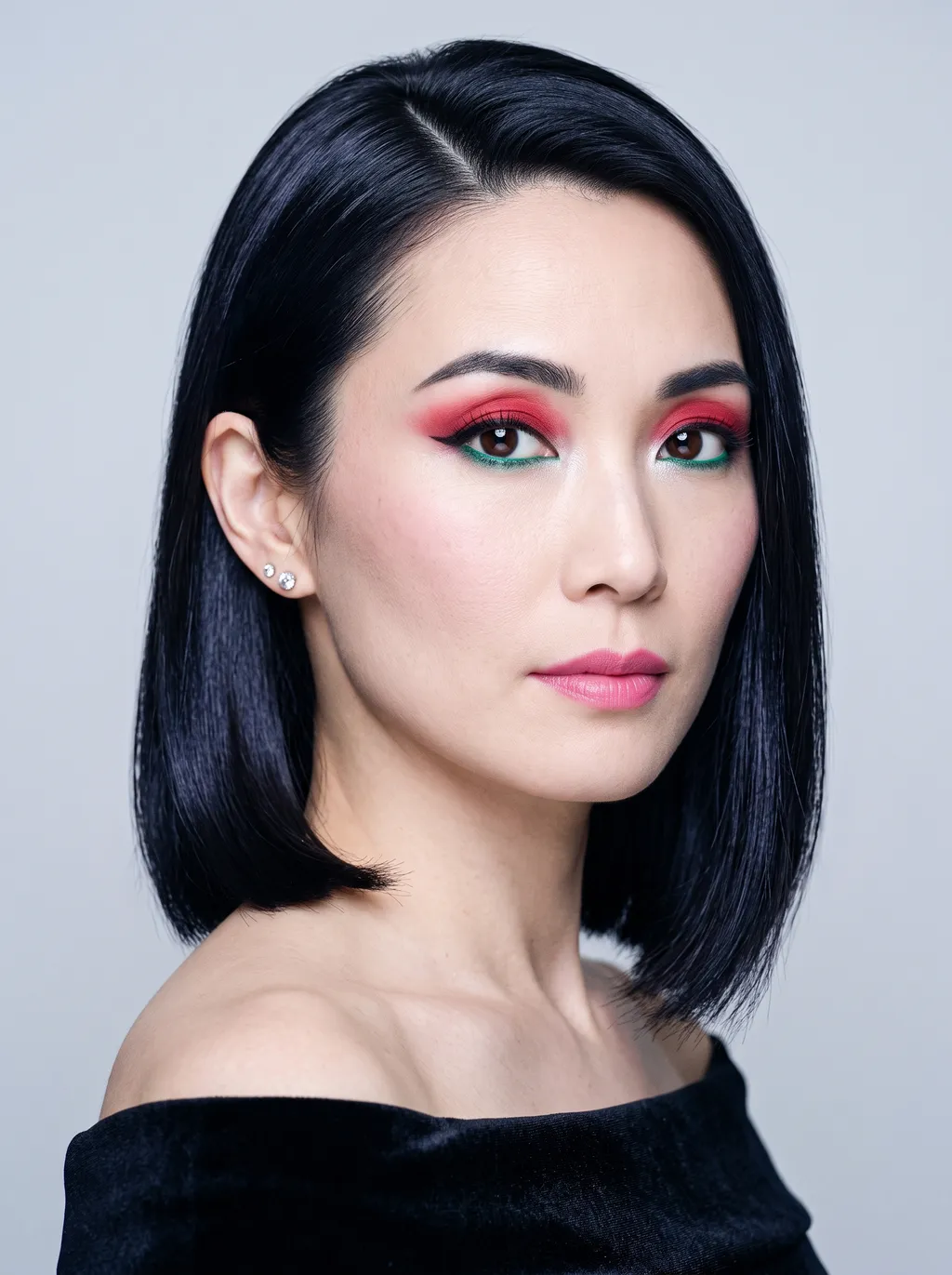 Full lid of clear cool red deepening to raspberry, an icy white inner corner, a sharp black wing, and emerald kohl in the lower waterline on Bright Winter coloring