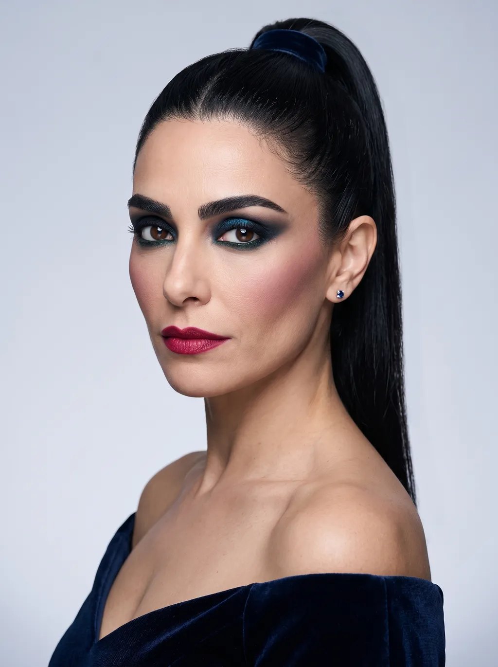 Black velvet eyelid topped with a sapphire-to-emerald multichrome, a midnight-navy smoke, and deep bottle green under the lashes on Dark Winter coloring