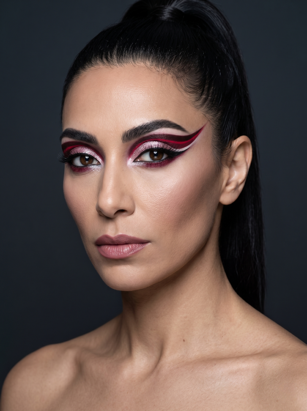 Dark Winter festival eye with a solid crimson graphic wing cut through by a clean stripe of negative space, over a pink-white shimmer lid with a black tightline beneath