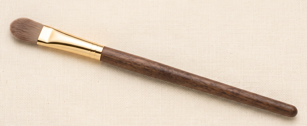 Small, flat tapered concealer brush for precise under-eye and blemish coverage