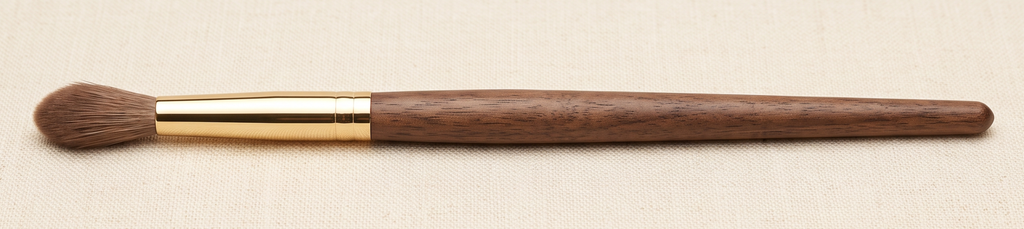 Tapered crease brush with a pointed, fluffy tip for blending eyeshadow in the socket line