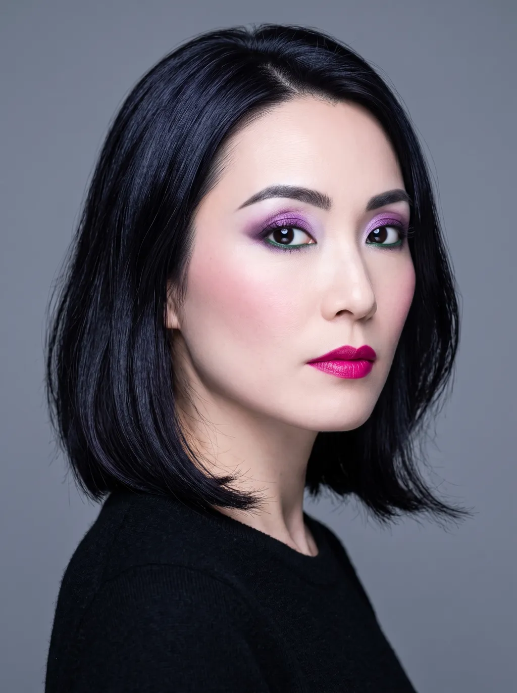 Vivid-amethyst eyeshadow with a bright forest-green lower lash line and a vivid-magenta lip on Bright Winter coloring