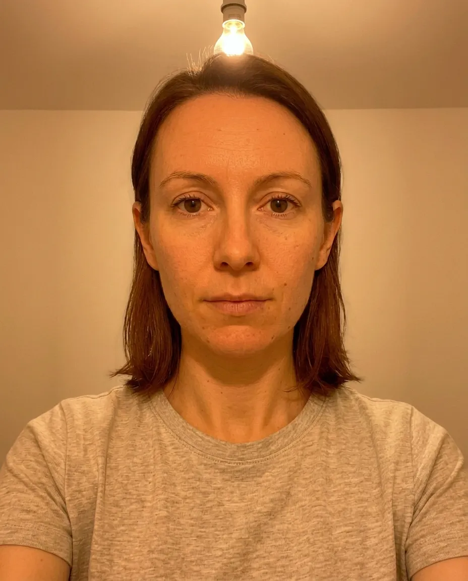Selfie taken under harsh overhead fluorescent lighting showing a greenish color cast on skin