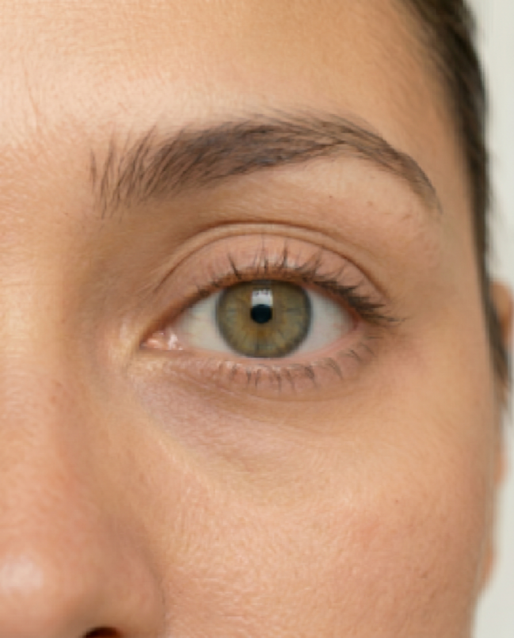 Eye area cropped from a standard distance selfie showing limited detail of iris and lid
