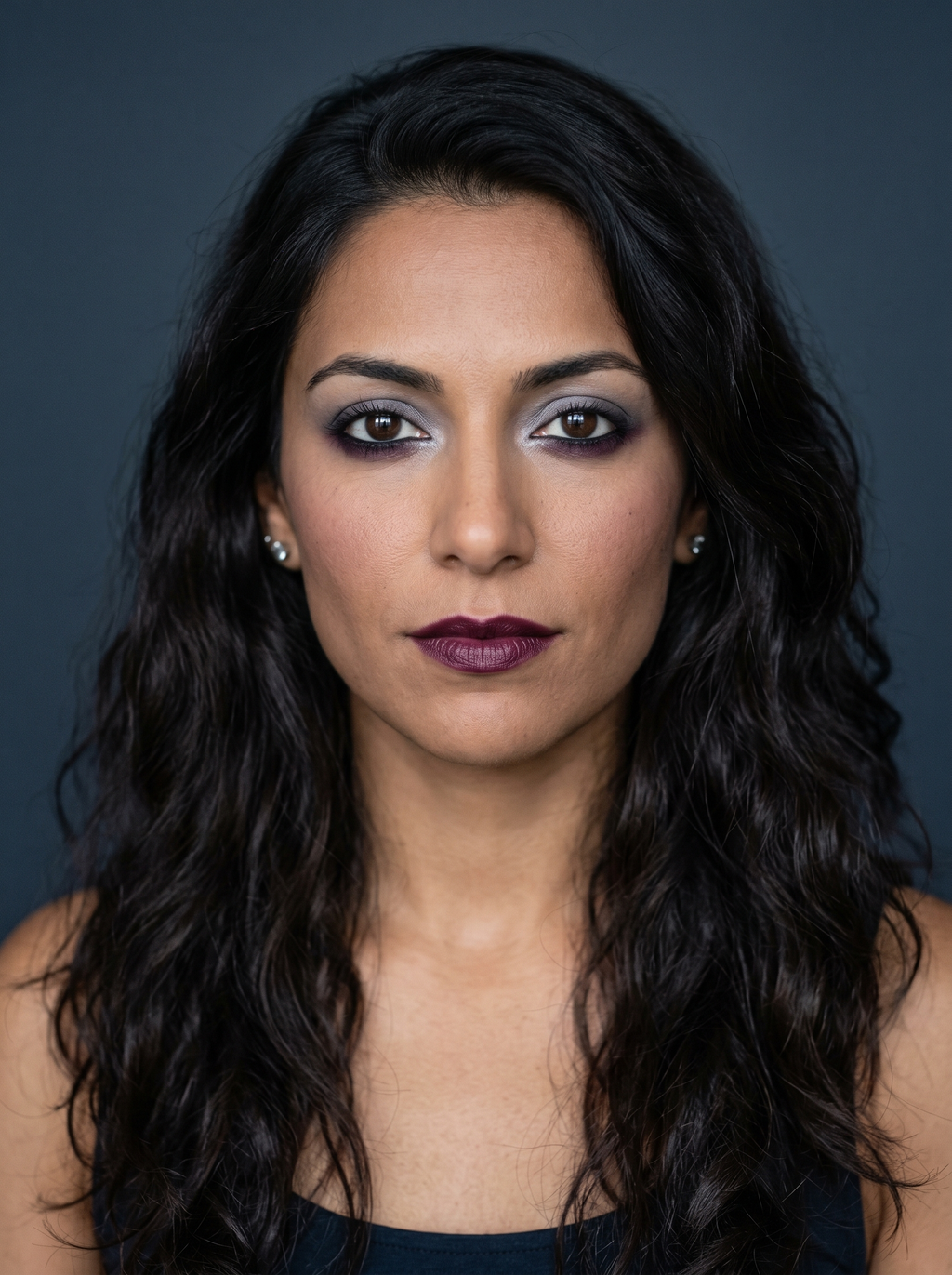 Reverse smoky eye with quiet pewter upper lid and jewel plum lower lash emphasis on Dark Winter coloring